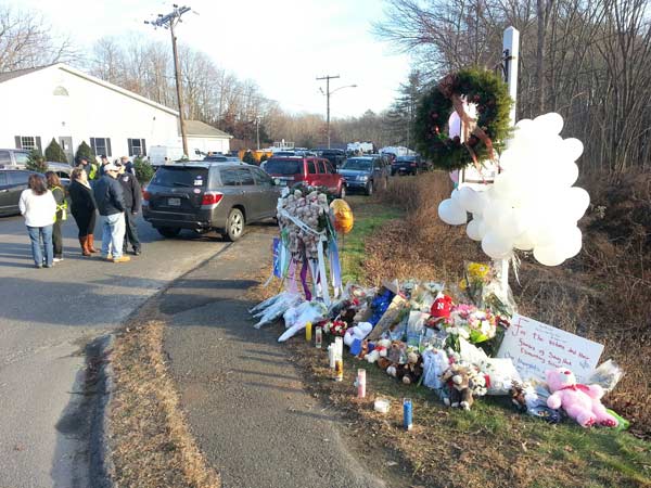 A makeshift memorial of flowers, candles and...