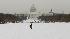 A woman walks through the snow on the National Mall in Washington.