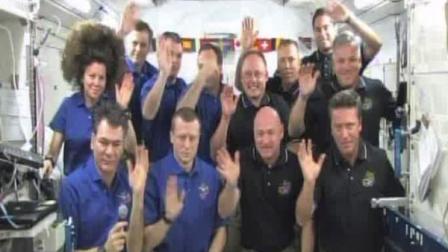 This image provided by NASA television shows the crews of the space shuttle Endeavour, in black shirts, and the International Space Stations Expedition 27 wave goodbye after speaking with Pope Benedict XVI at the Vatican Saturday May 21, 2011.