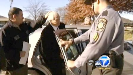 Former Penn State defensive coordinator Jerry Sandusky is seen being taken by police in Bellefonte, Pa., on Saturday, Nov. 5, 2011.