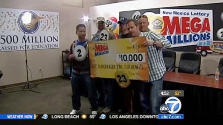 A group of firefighters in New Mexico pose with their Mega Millions winnings, which they are donating to a sick co-worker.