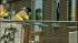 An official is seen peeking inside the window of...