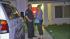 SD police remain at suspect's family home :: A San Diego police officer is seen standing with a woman outside the home belonging to the parents of suspected Aurora, Colo. shooter James Holmes on Friday, July 20, 2012.