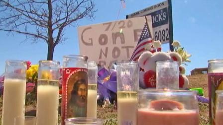 A makeshift memorial of candles, flowers and other items grows to honor the victims killed in the Aurora, Colo. theater shooting.