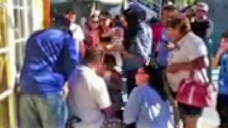 A still from footage shows people gathering after an airplane ride flipped over with two children on board at Adventure City in Anaheim in August 2012.