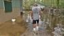 A man is seen wading through a flooded neighborhood following Hurricane Isaac in this undated file photo.
