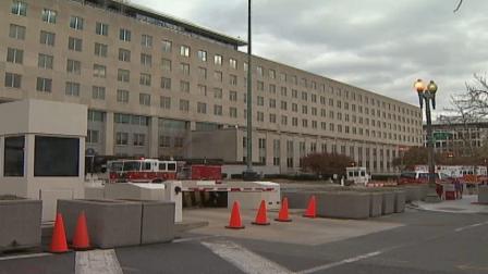 Fire officials are shown at the scene where a fire broke out at the State Department in Washington on Saturday, Nov. 24, 2012.