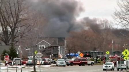 Police investigate a shooting at the scene of a house fire in Webster, N.Y., on Monday, Dec. 24, 2012.