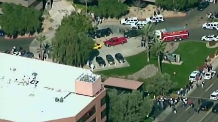 Multiple police vehicles and fire trucks were seen outside a Phoenix office complex, where three people were shot on Wednesday, Jan. 30, 2013.