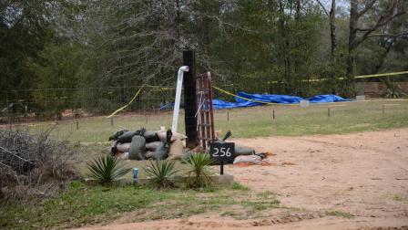 A tent covers the bunker where where a 5-year-old boy was rescued by law enforcement after being held for nearly a week. FBI agents placed the blue tent over the bunker to protect evidence below.