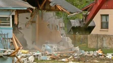 Crews began the demolition of a Florida home over a sinkhole where a man is presumed dead after being swallowed by the earth. The demolition, seen above, started on Sunday, March 3, 2013.