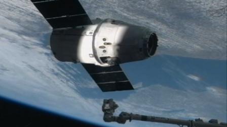 SpaceXs Dragon Capsule is seen on the end of the International Space Stations robotic arm on Sunday, March 3, 2013.