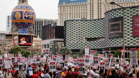 Culinary Union workers demonstrate along Las Vegas Boulevard outside the Cosmopolitan Hotel and Casino while protesting their contract negotiations with Deutsche Bank, Wednesday, March 20, 2013, in Las Vegas.