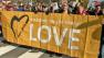People march with a sign reading, Standing on the side of love in this March 2013 photo.