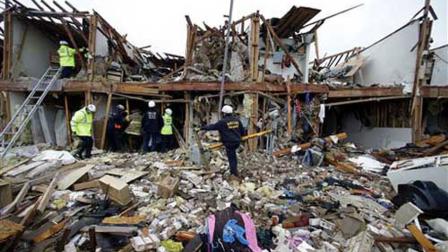 Firefighter conduct search and rescue of an apartment destroyed by an explosion at a fertilizer plant in West, Texas, Thursday, April 18, 2013.