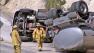 Firefighters examine an overturned tanker that was transporting fuel when it flipped over in Angelus Oaks on Friday, April 26, 2013. The accident shut roads and caused a hazard to the nearby Santa Ana River Basin.