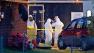 Federal authorities wear hazmat suits as they search the home of Everett Dutschke, April 23, 2013 in Tupelo, Miss., in connection with the recent ricin attacks.