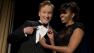 First lady Michelle Obama and late-night television host and comedian Conan OBrien gesture to his tie at the White House Correspondents Association Dinner at the Washington Hilton Hotel, Saturday, April 27, 2013, in Washington.