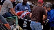 A survivor is carried out of the damage area after a deadly tornado hit Moore, Okla., Monday, May 20, 2013.