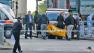 Police officers carry equipment while investigating a crime scene of an apparent attack that left one man confirmed dead and two people wounded near Woolwich barracks in London, May 22, 2013.