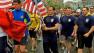 Runners hold an American flag as they finish the last mile of the Boston Marathon on Saturday, May 25, 2013.