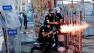 A riot policeman launches a tear gas canister during clashes in Taksim square in Istanbul, Tuesday, June 11, 2013.