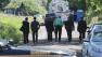 Law enforcement officials walk back to the search area after Robert Foley, special agent in charge of the FBIs Detroit division, addressed the media in Oakland Township, Mich., Wednesday, June 19, 2013.