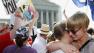 American University students Sharon Burk, left, and Molly Wagner, embrace outside the Supreme Court in Washington, Wednesday, June 26, 2013.