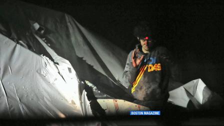 Boston Marathon bombing suspect Dzhokhar Tsarnaev emerges from a covered boat as a sniper trains a laser target at his head.