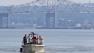 Rescue workers on a boat search the Hudson River south of the Tappan Zee Bridge for two people who are believed to have fallen into the water during a boat crash in Piermont, N.Y. on Saturday, July 27, 2013.