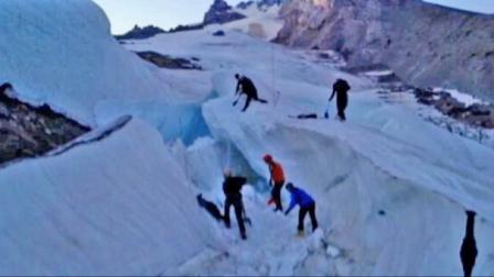 Rescue workers chip away at tons of ice and snow Sunday, Aug. 4, 2013, to recover the body of a snowboarder killed when an ice tunnel collapsed in Oregons Mount Hood.
