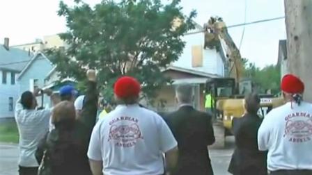 Spectators watch as Ariel Castros house is torn down in Cleveland Wednesday, Aug. 7, 2013.