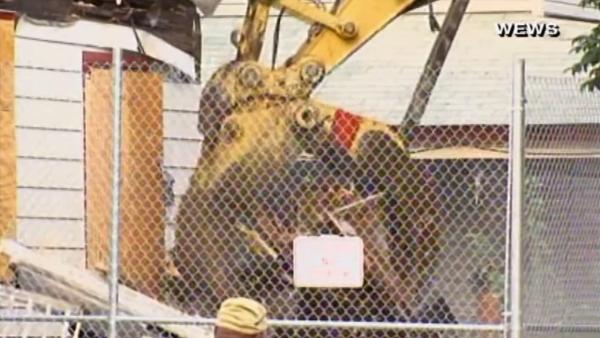 Ariel Castro's Cleveland house is torn down Wednesday, Aug. 7, 2013. Gina DeJesus, Michelle Knight and Amanda Berry were held captive and raped at the house for over a decade before escaping May 6.
