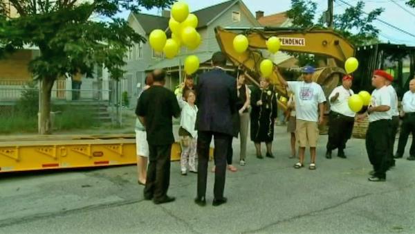 Michelle Knight, one of three women held captive in Ariel Castro's Cleveland house, gathers with a crowd of people to release balloons before the house is torn down Wednesday, Aug. 7, 2013.