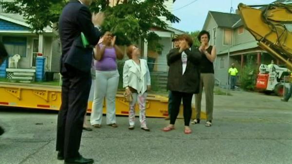 Michelle Knight, one of three women held captive in Ariel Castro's Cleveland house, looks up after she and a crowd of people released balloons before the house is torn down Wednesday, Aug. 7, 2013.