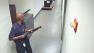 This image from video provided by the FBI, shows Aaron Alexis moves through the hallways of Building #197 at the Washington Navy Yard on Monday, Sept. 16, 2013, in Washington, carrying a Remington 870 shotgun.