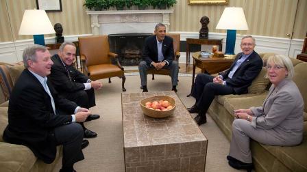 Sen. Dick Durbin, D-Ill., Sen. Chuck Schumer, D-N.Y., President Barack Obama, Senate Majority Leader Harry Reid of Nev., Sen. Patty Murray, D-Wash., look to photographers as they meet in the Oval Office of the White House.