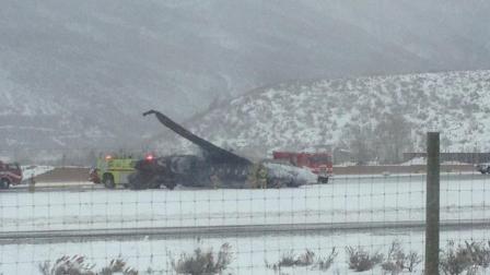 The wreckage of a plane crash is seen at Aspen Airport on Sunday, Jan. 5, 2014.