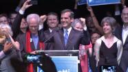 Eric Garcetti is shown raising his hands behind a podium in thsi May 2013 photo.