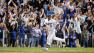 Fans cheer as Los Angeles Dodgers Juan Uribe rounds the bases after hitting a two-run home run against the Atlanta Braves in the eighth inning of Game 4 in the National League baseball division series Monday, Oct. 7, 2013, in Los Angeles.
