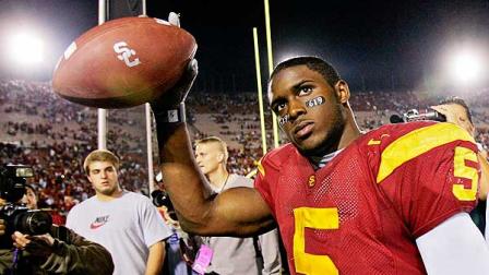 Southern California tail back Reggie Bush walks off the field holding the game ball after the Trojans defeated Fresno State, 50-42 in this Nov. 19, 2005 file photo from the Los Angeles Coliseum.
