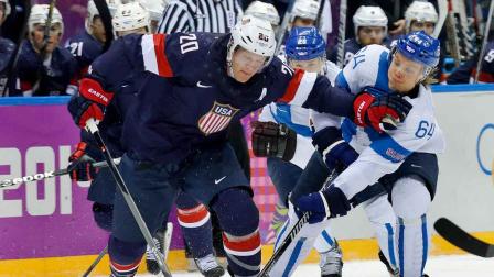 USA defenseman and Finland forward Mikael Grandlund vie for the puck during the second period of the mens bronze medal ice hockey game at the 2014 Winter Olympics, Saturday, Feb. 22, 2014, in Sochi, Russia.