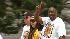 Magic Johnson flashes the victory sign during...