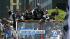 Los Angeles Kings players wave from atop a bus...
