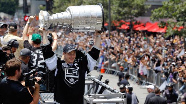 Los Angeles Kings' Dustin Brown hoists the Stanley Cup during a parade celebrating the team's NHL hockey Stanley Cup championship in Los Angeles, Thursday, June 14, 2012.