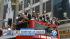 Los Angeles Kings players wave from atop a bus...