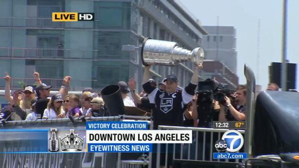 Los Angeles Kings' Dustin Brown hoists the Stanley Cup during a parade celebrating the team's NHL hockey Stanley Cup championship in Los Angeles, Thursday, June 14, 2012.