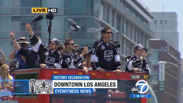 Los Angeles Kings players wave from atop a bus during a parade celebrating the team's NHL hockey Stanley Cup championship in Los Angeles, Thursday, June 14, 2012.
