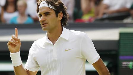 Switzerlands Roger Federer gestures with his finger after defeating Colombias Alejandro Falla at the All England Lawn Tennis Championships at Wimbledon, Monday, June 21, 2010.