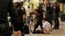 Police are seen with a man on a sidewalk following 12 arrests at an Occupy San Francisco protest on Saturday, Oct. 6, 2012.